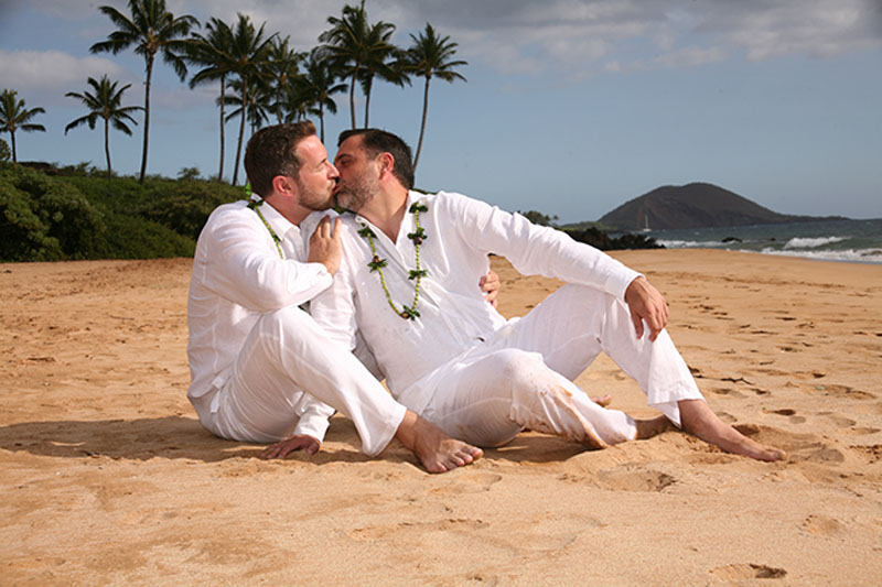 grooms kiss at their wedding in Hawaii