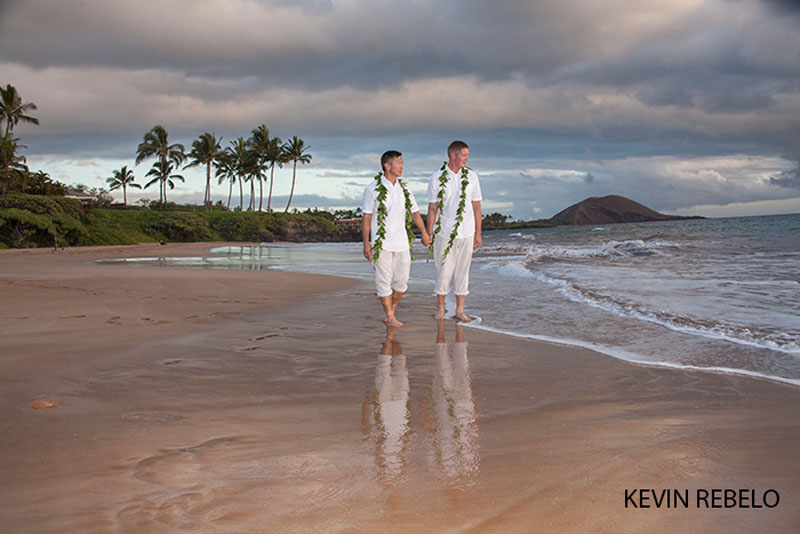 nice gay wedding on maui as two men walk on beach