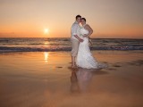 brides in water at makena beach wedding